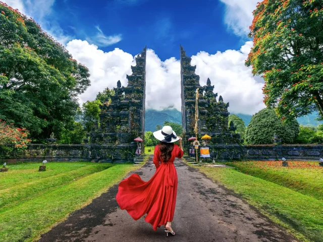 woman-walking-big-entrance-gate-bali-indonesia-1